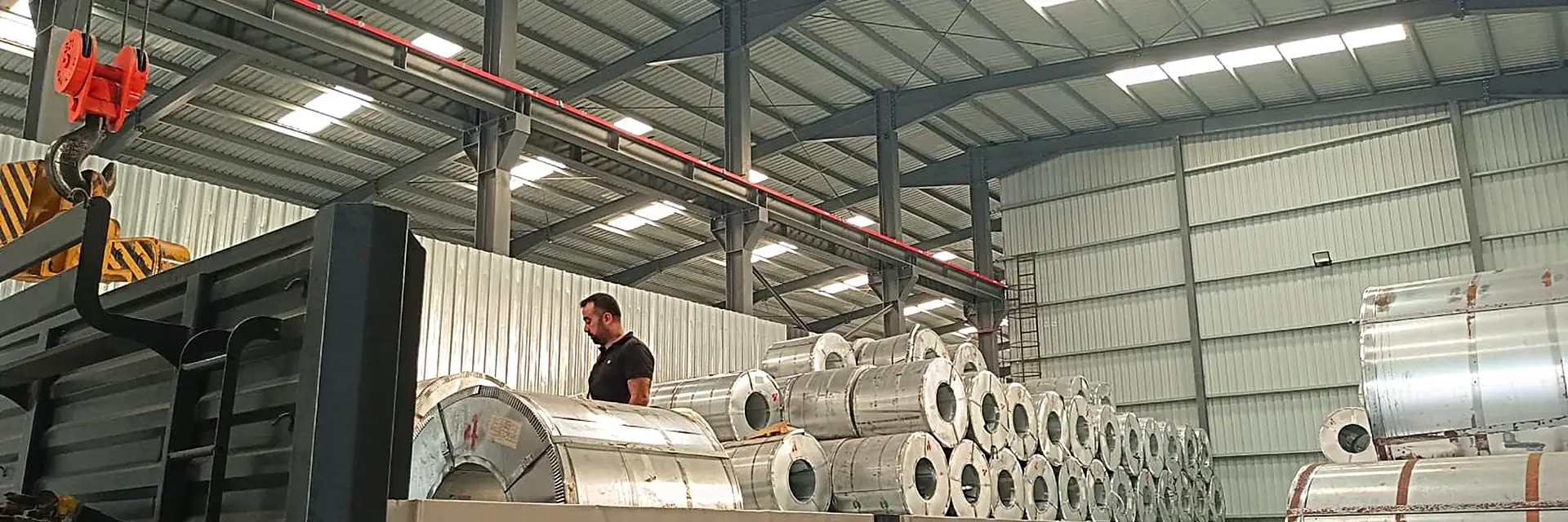 A galvanised steel coil being loaded onto a truck bed by Kral Antrepo staff