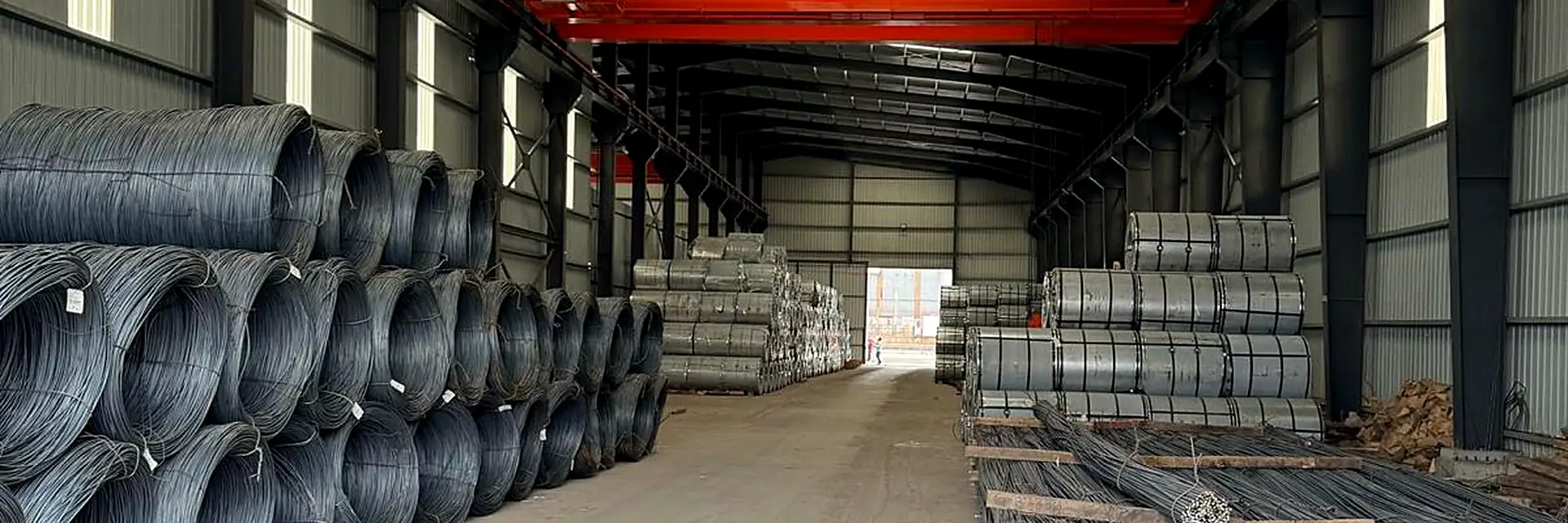 Wire rod coils and steel coil stacks in the warehouse aisle