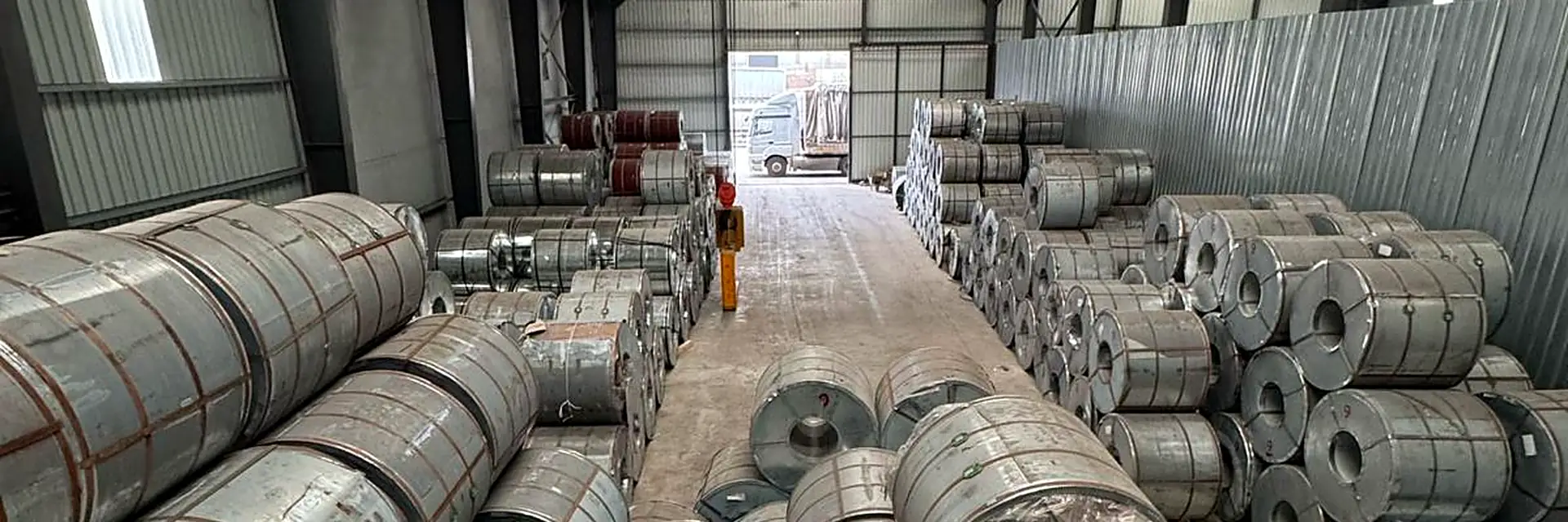 Close-up of stacked galvanised steel coils
