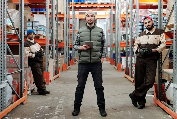 Warehouse staff taking stock in front of the racking
