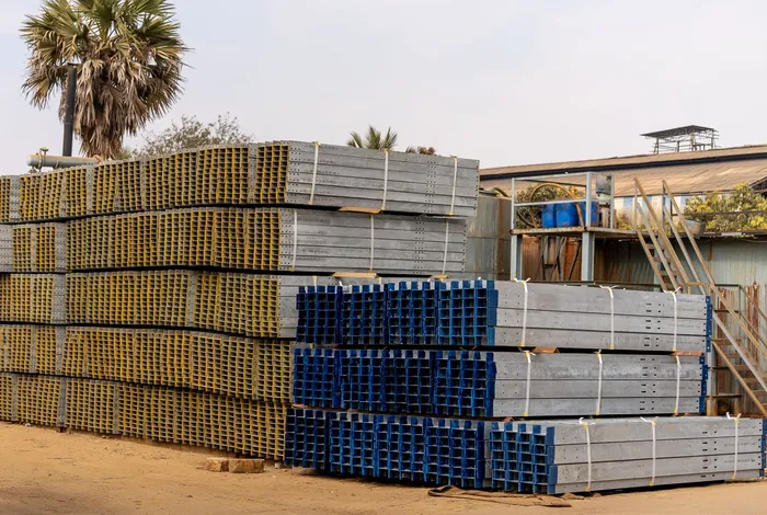Bundled and stacked steel sections in an industrial yard