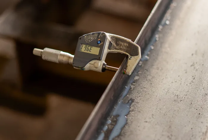 Measuring sheet thickness with a micrometer